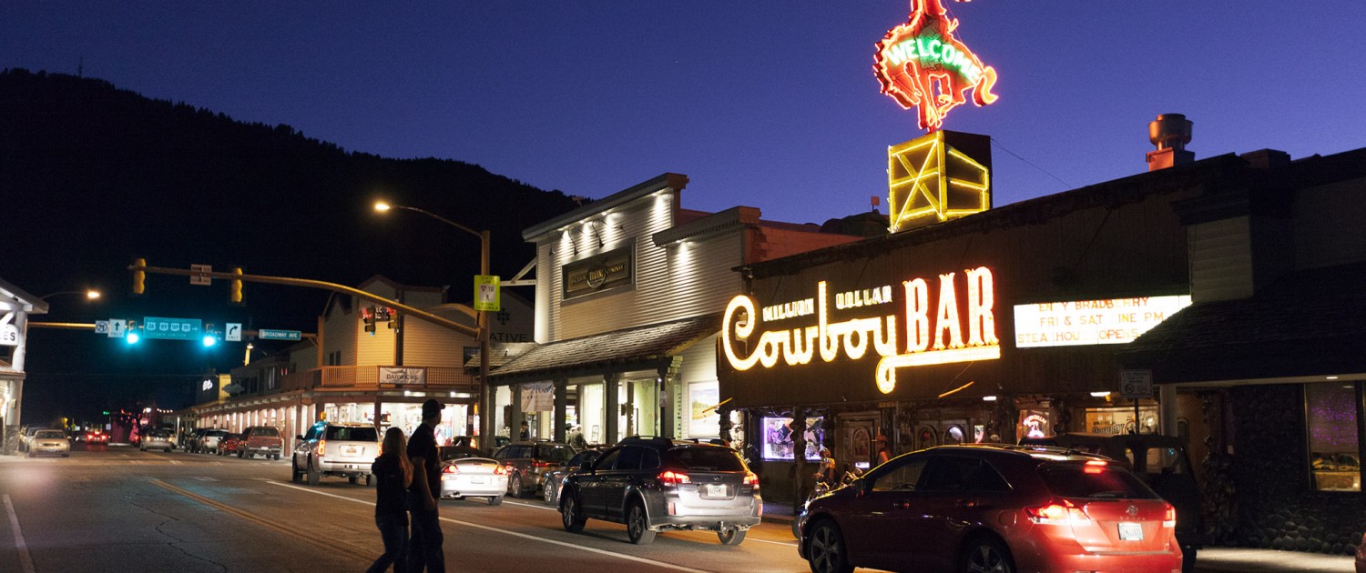 The neon lights of the world famous Cowboy Bar illuminate the Jackson Hole boardwalk.